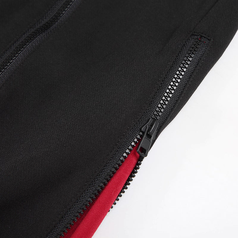 Close-up of a black zipper on a garment with a red interior.