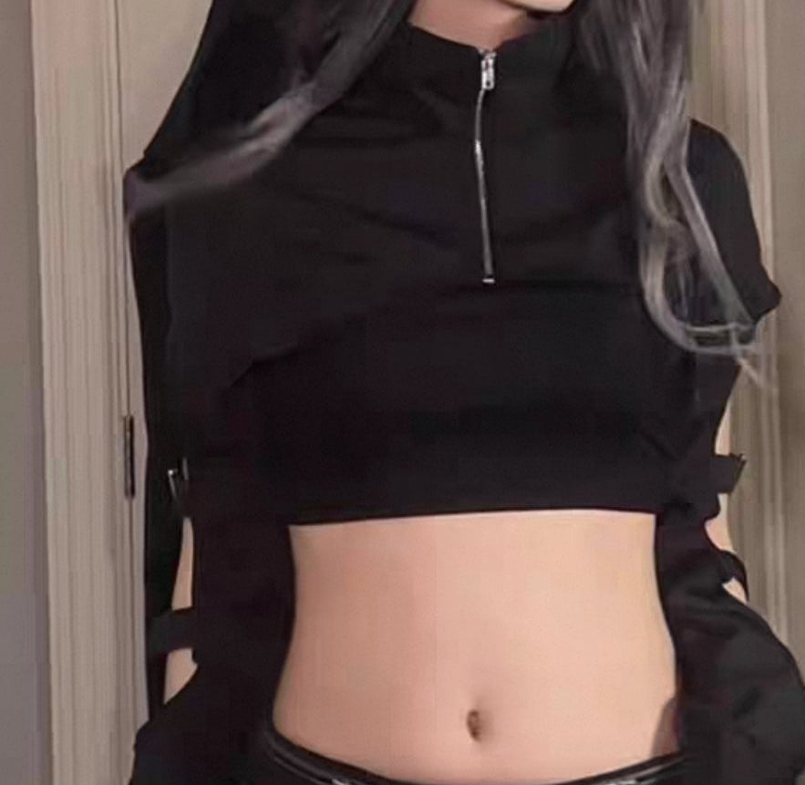 Person wearing a black hoodie and pants in a room with a door and wall socket.