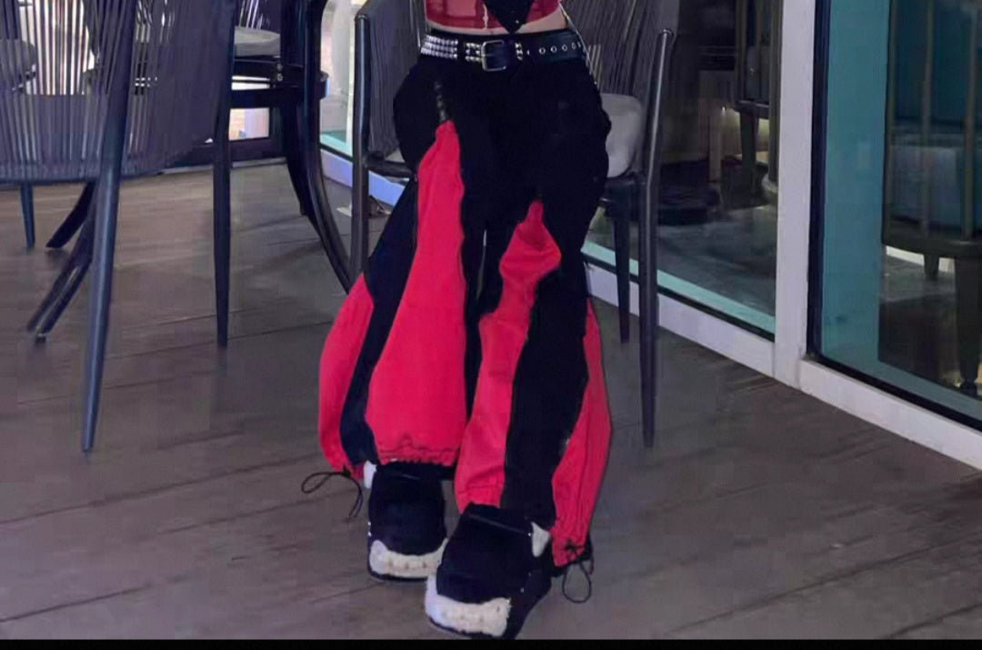 Person wearing a red and black outfit with large shoes in an indoor setting